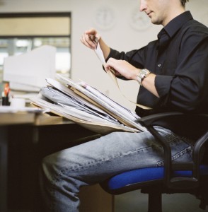 Man with Stack of Paperwork at the Office